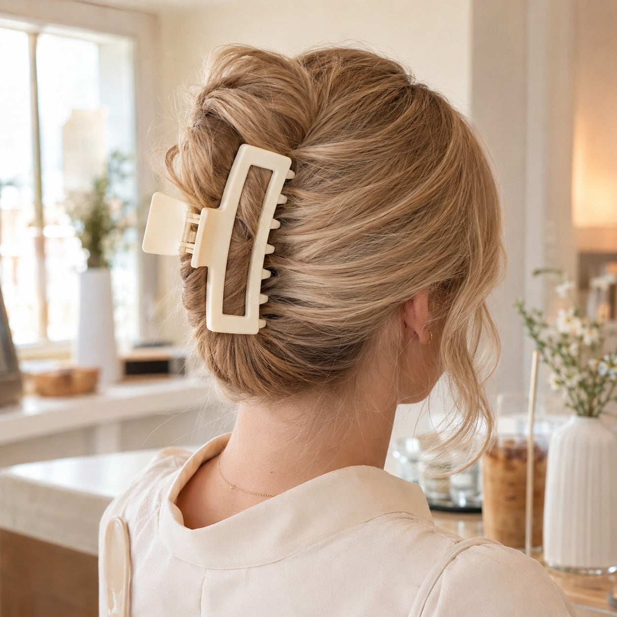 Blonde updo held in place with the ivory ClipLuxe claw clip