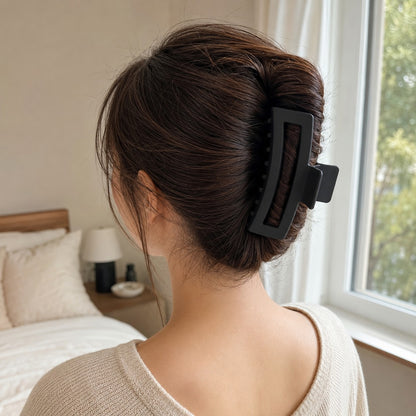 Dark hair updo held with the black ClipLuxe claw clip