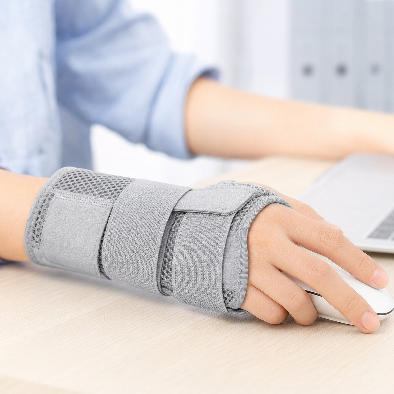 Wearing the grey FlexWrist brace while typing