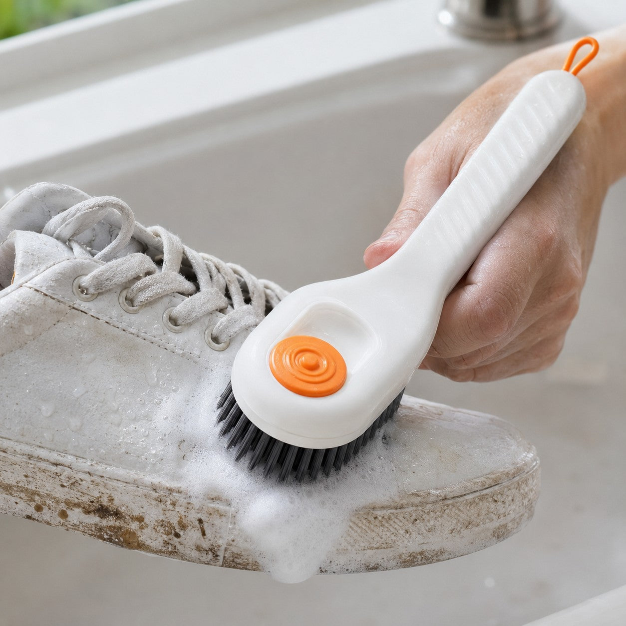 Scrubbing a dirty sneaker with the FoamGlide brush