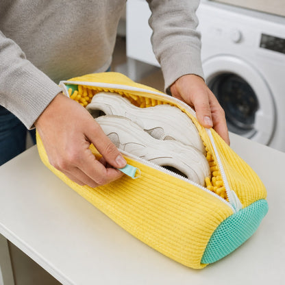 Loading trainers into the FreshSole washing bag