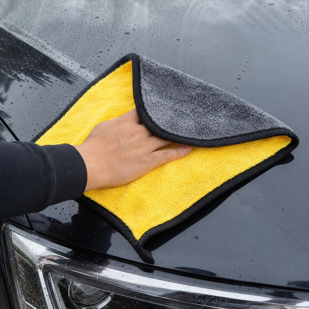 Wiping a car bonnet with the GleamPro microfiber cloth