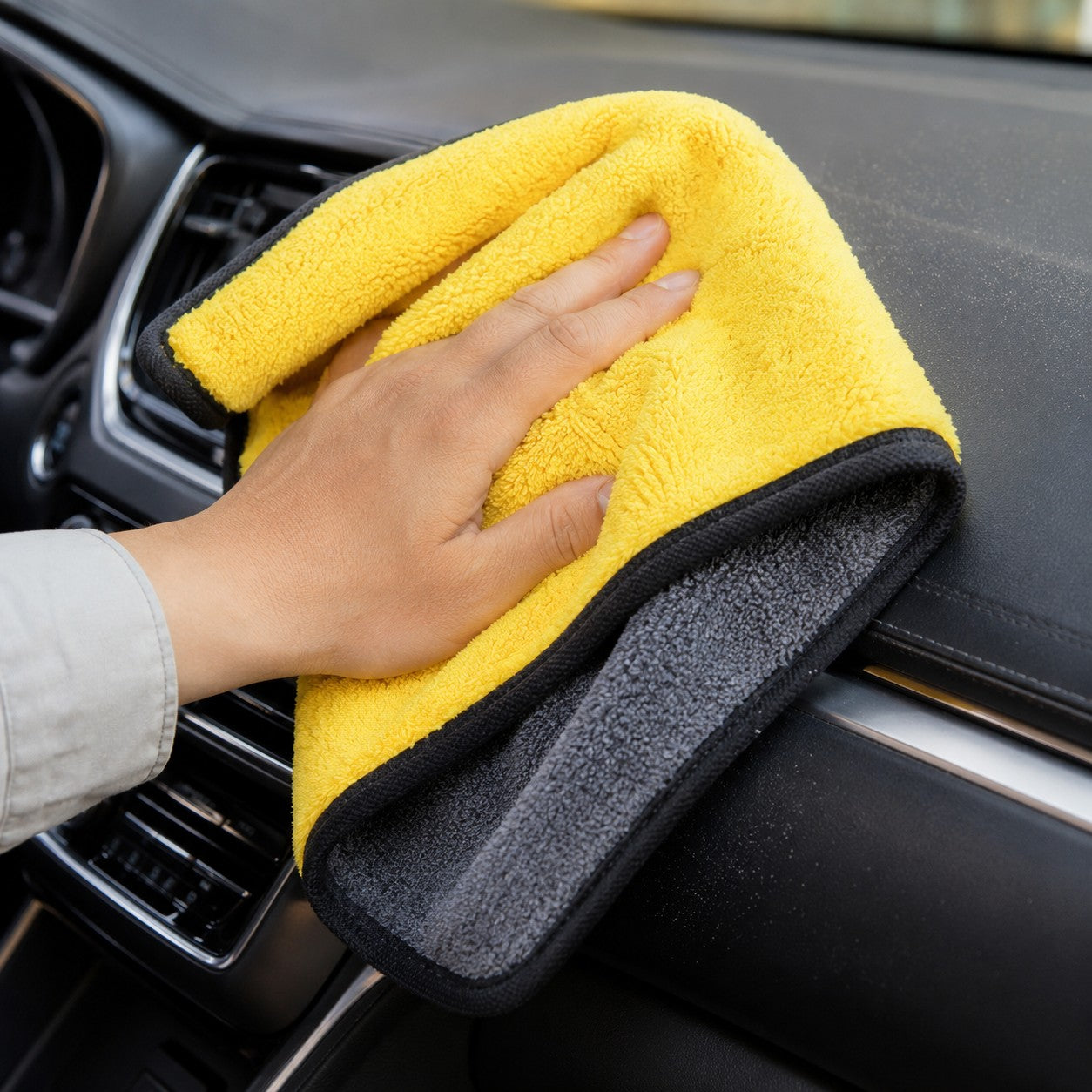 Wiping the car dashboard with the GleamPro cloth