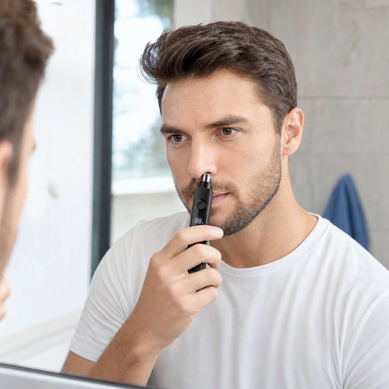 Man using the GlideTrim nose and ear hair trimmer