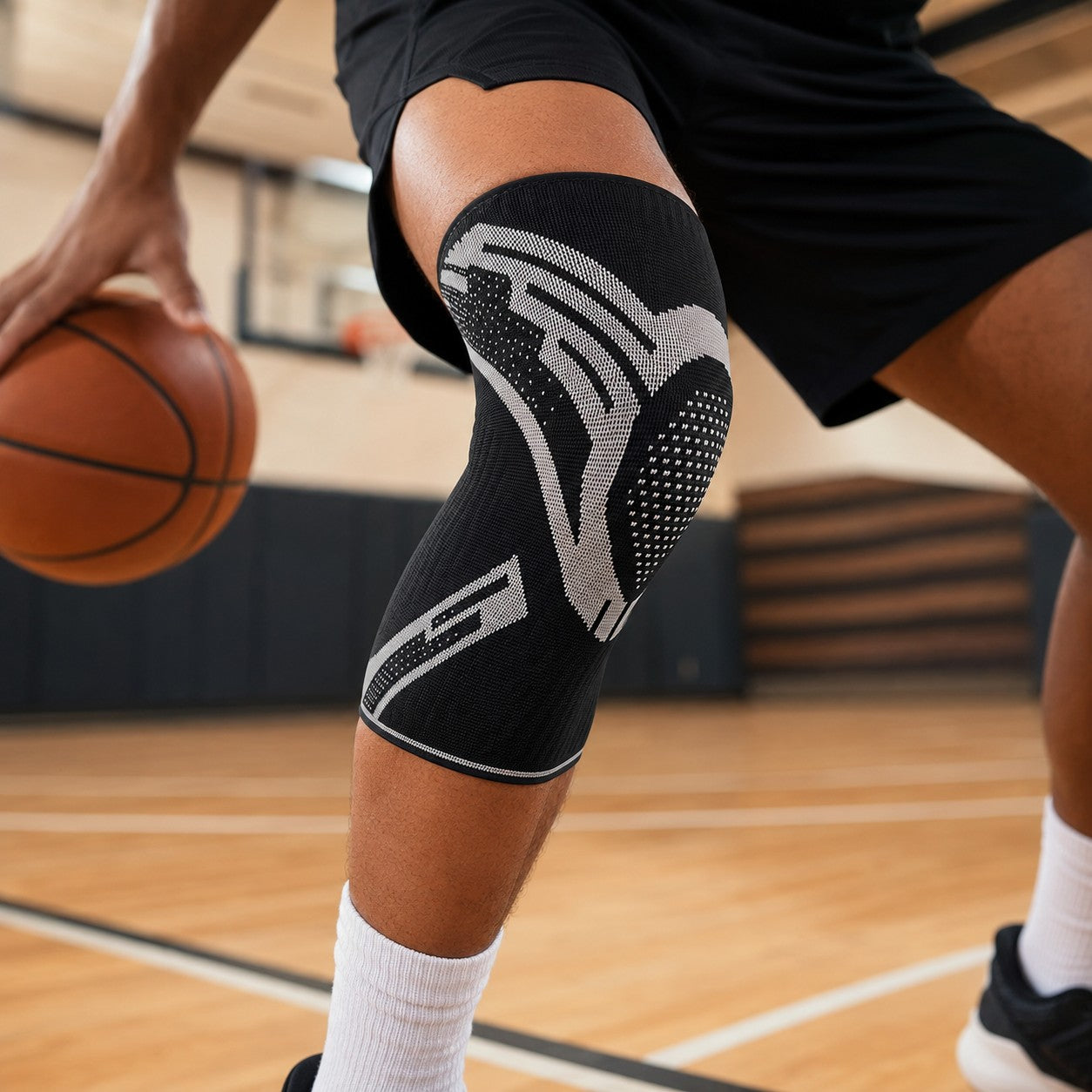 Playing basketball wearing the black KneeGuard knee sleeve