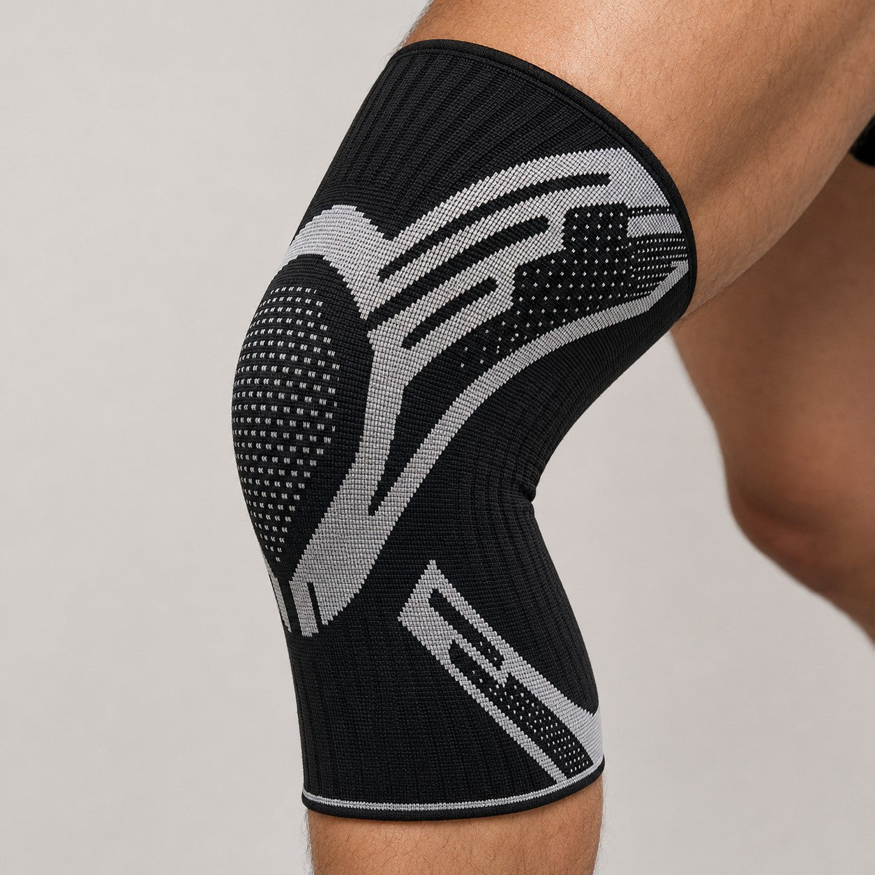Close-up of the KneeGuard compression knee sleeve in white worn on the knee