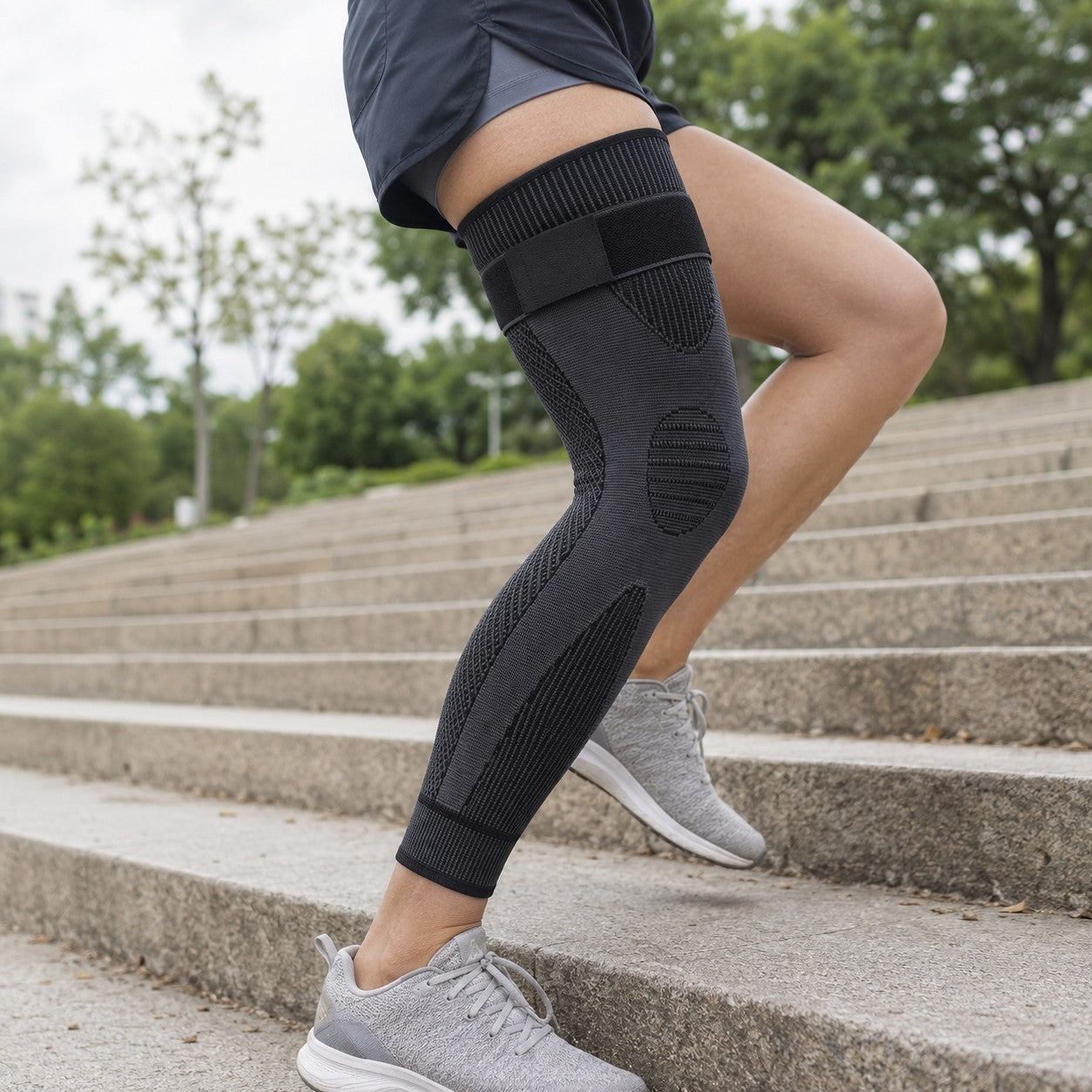 Close-up wearing the black LegGuard full-leg compression sleeve on stairs